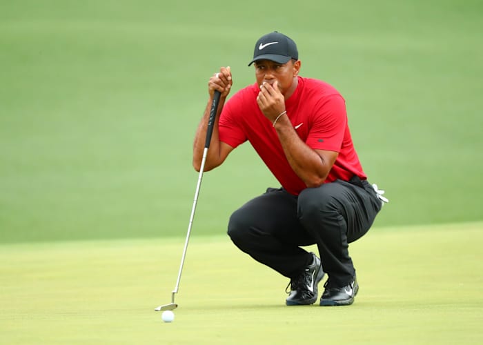 Tiger Woods lines up a putt during the final round of The Masters golf tournament.